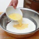 Break the eggs into the sieved flour