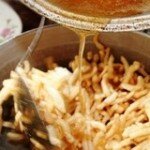 Pour the syrup over the fried strips of dough