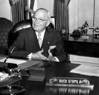 Harry Truman poses for a photograph at the recreation of the Truman Oval Office at the Truman Library in 1959.